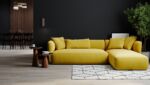 A living room with a yellow sectional couch, a black wall, and a wooden coffee table.